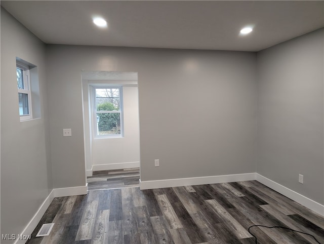 empty room with dark wood-type flooring