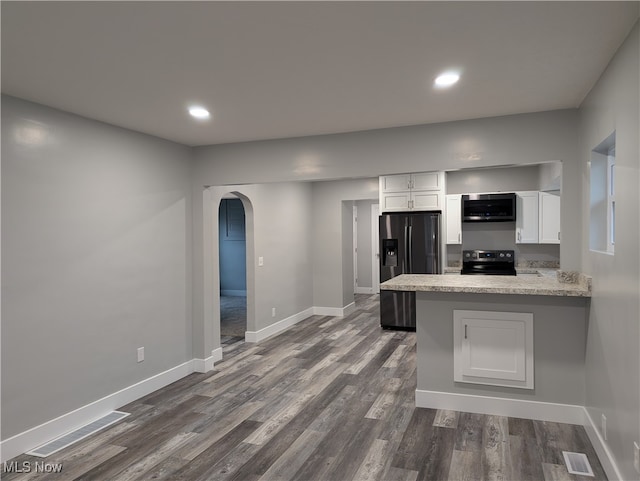 kitchen featuring white cabinets, appliances with stainless steel finishes, kitchen peninsula, and dark hardwood / wood-style floors