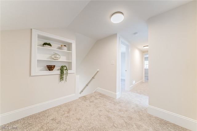 bonus room featuring vaulted ceiling, built in features, baseboards, and carpet floors