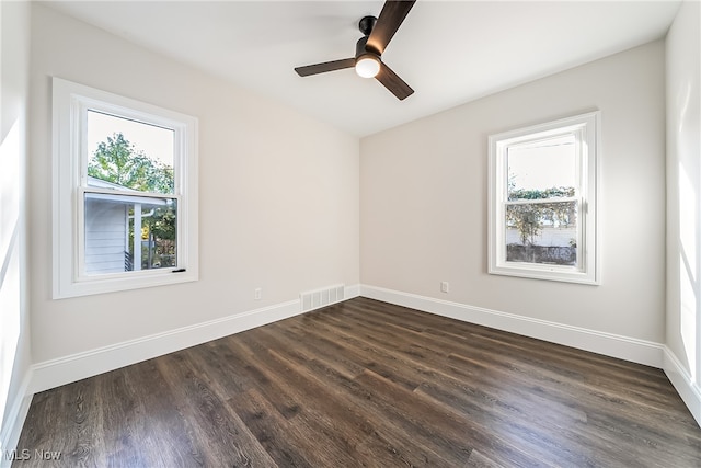 empty room with dark hardwood / wood-style flooring and ceiling fan