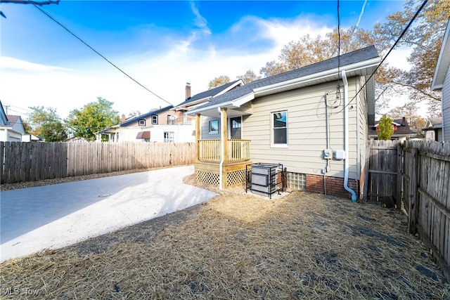 rear view of house with a patio area, a chimney, and a fenced backyard