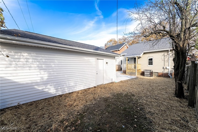 rear view of property featuring fence