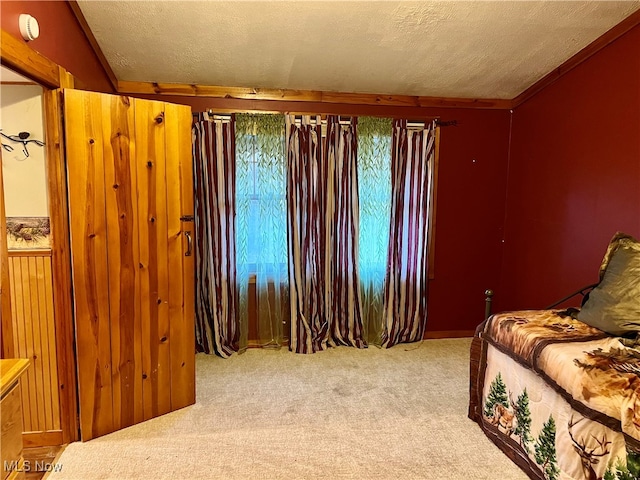 bedroom featuring a textured ceiling and carpet