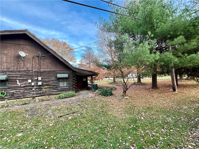 view of side of home featuring a yard