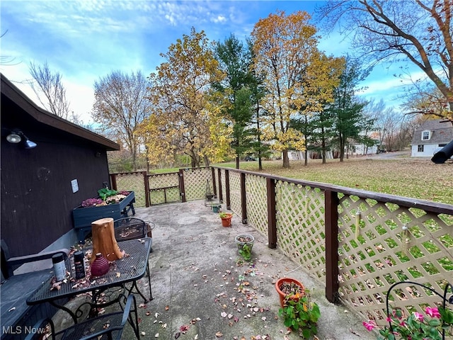 deck with a patio and a yard