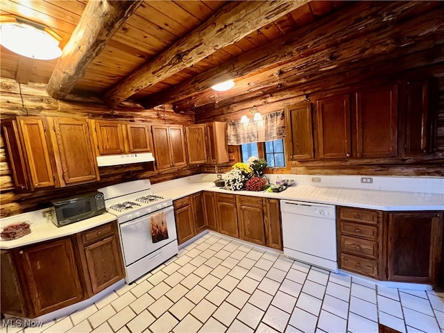 kitchen with white appliances, wood ceiling, light tile patterned flooring, and beam ceiling