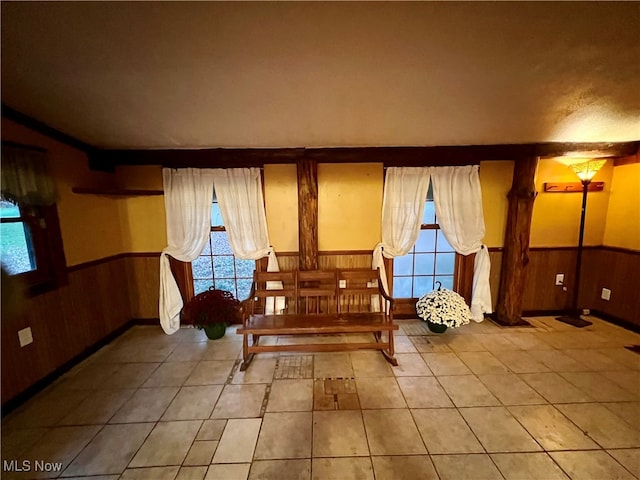 sitting room featuring wood walls and tile patterned floors