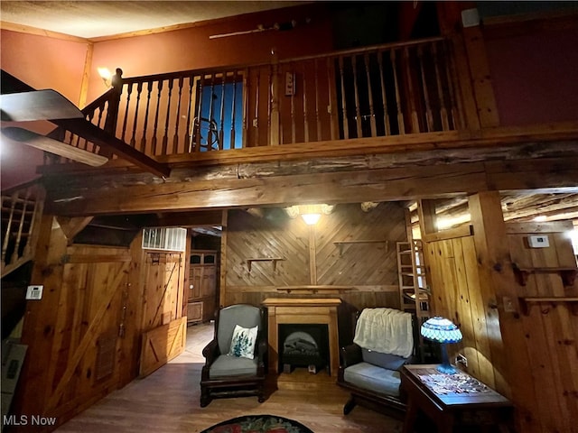 interior space with wood-type flooring and wooden walls