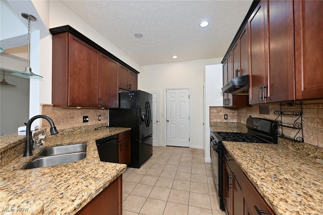 kitchen featuring sink, black appliances, tasteful backsplash, light stone countertops, and a textured ceiling