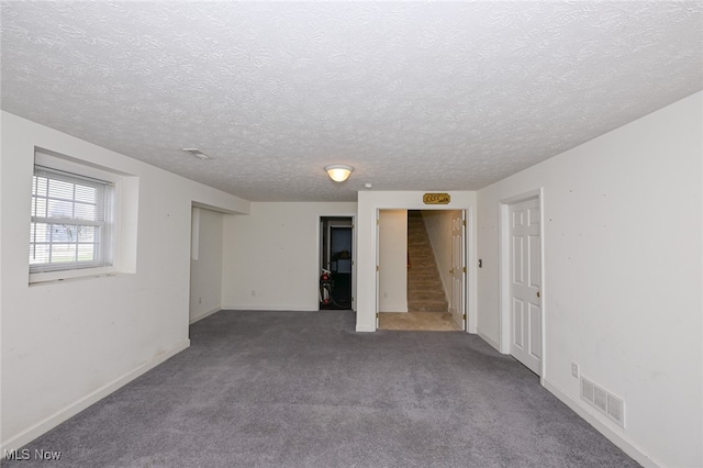 basement featuring carpet and a textured ceiling