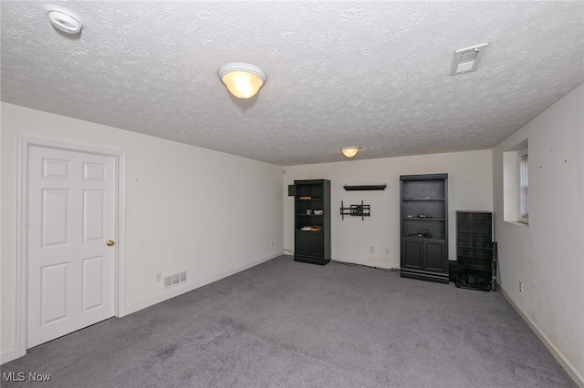 basement featuring a textured ceiling and light colored carpet