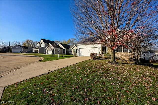 view of front of home featuring a garage and a front yard