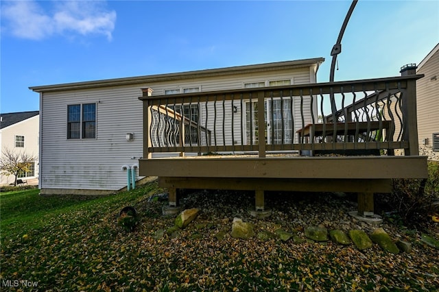 rear view of property with a wooden deck