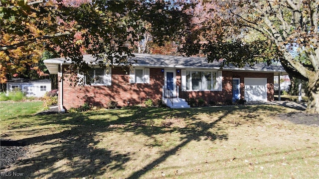 ranch-style house featuring a front lawn and a garage