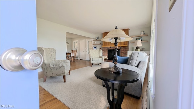 living room with a fireplace and light hardwood / wood-style flooring