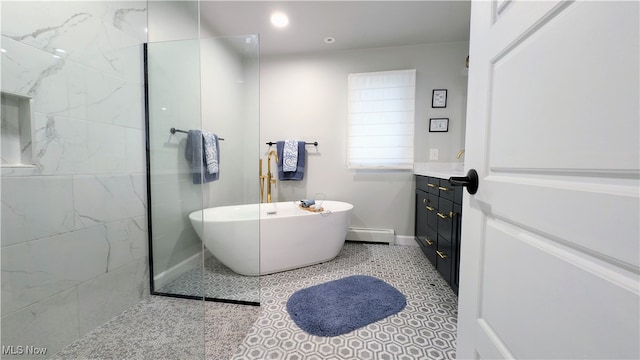 bathroom featuring a baseboard radiator, vanity, and a bath