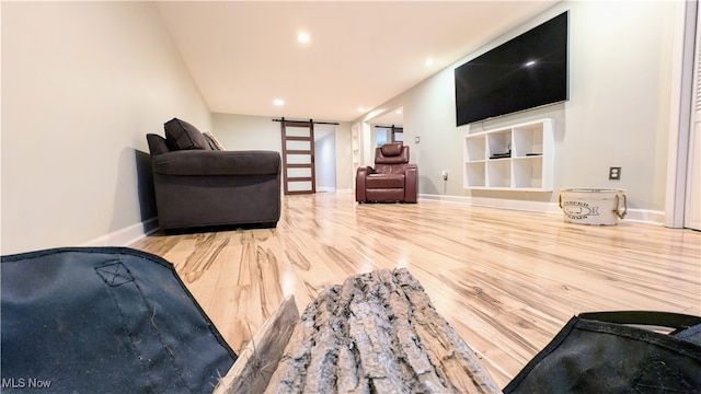 living room featuring wood-type flooring and a barn door