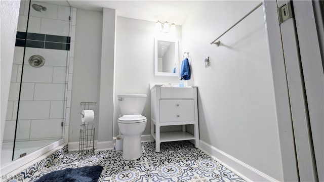 bathroom featuring toilet, vanity, an enclosed shower, and tile patterned floors