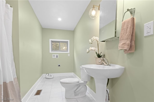 bathroom with toilet and tile patterned flooring