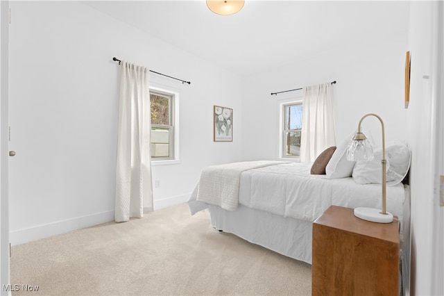 bedroom featuring light colored carpet