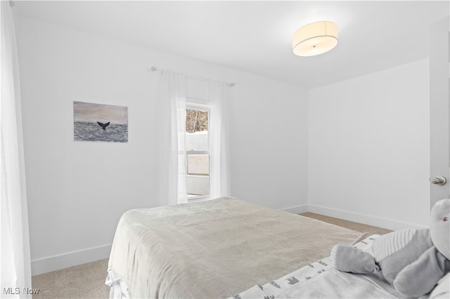 bedroom featuring light carpet