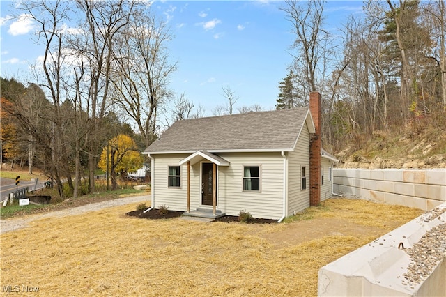 bungalow-style house featuring a front lawn