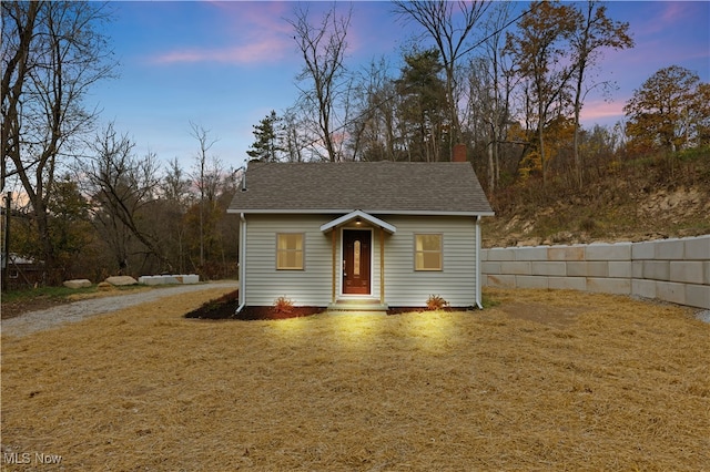 bungalow-style home with a lawn