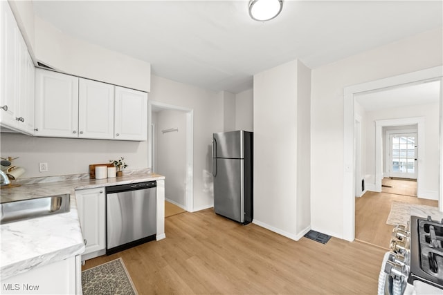 kitchen featuring sink, light wood-type flooring, white cabinetry, and stainless steel appliances