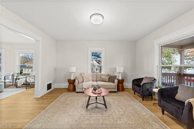 living room featuring a wealth of natural light and light hardwood / wood-style floors