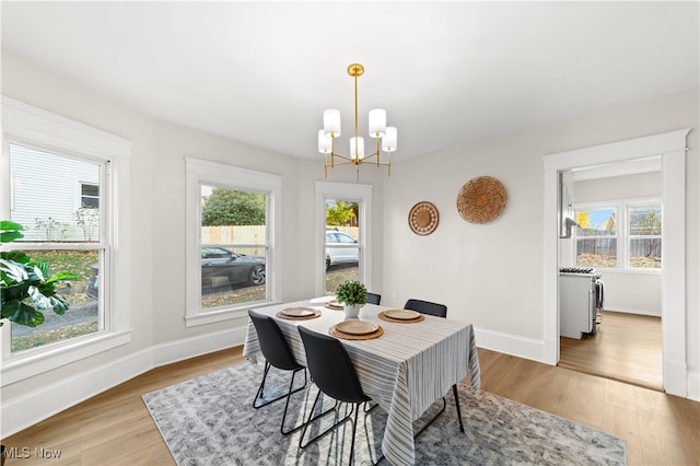 dining space with a chandelier and hardwood / wood-style flooring