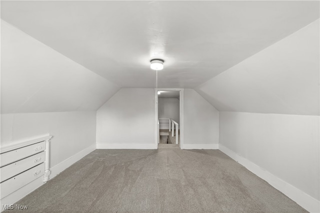 additional living space featuring carpet floors and vaulted ceiling