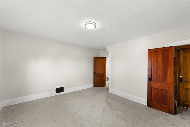 empty room featuring light colored carpet