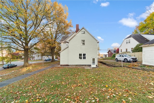 view of side of property with a lawn