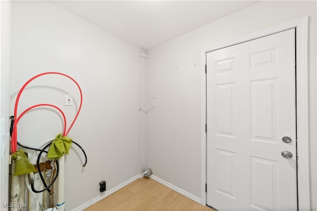 laundry area with light hardwood / wood-style flooring