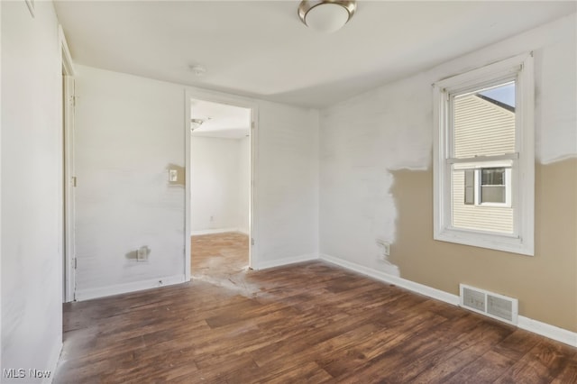 unfurnished room featuring dark wood-type flooring