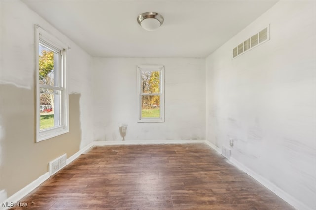 empty room with dark hardwood / wood-style floors