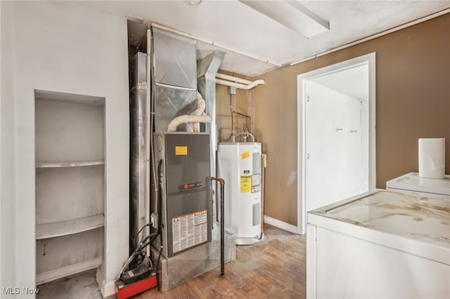 utility room with water heater, washer / clothes dryer, and heating unit