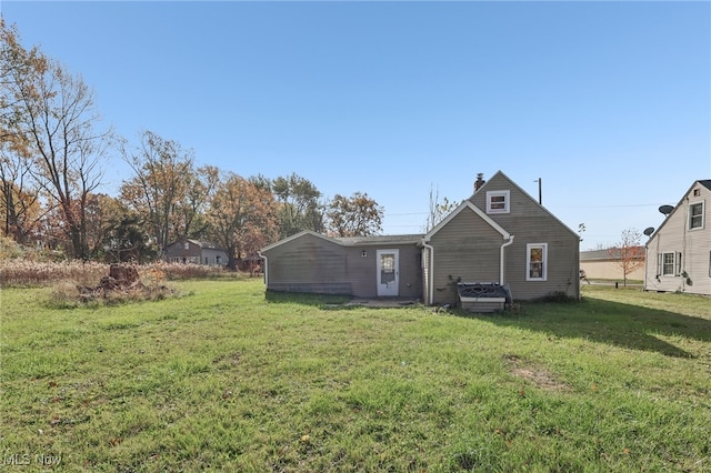 rear view of house with a yard