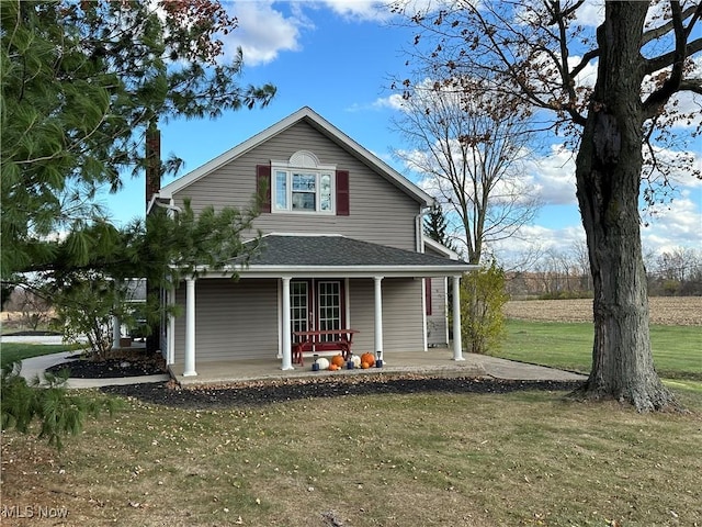 view of front of home with a porch and a front yard