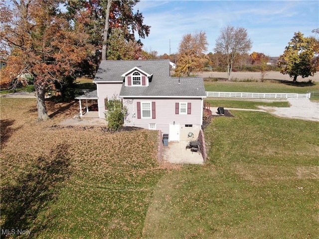 exterior space with a lawn, a rural view, and a patio