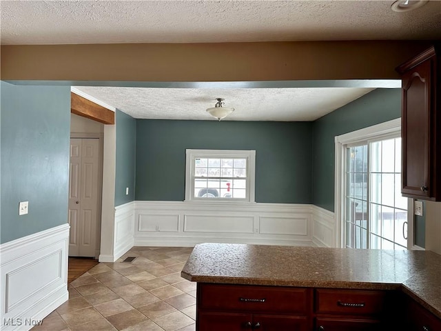 kitchen with light tile patterned floors and a textured ceiling