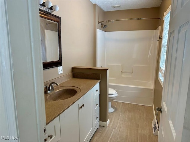 full bathroom featuring shower / tub combination, vanity, and toilet