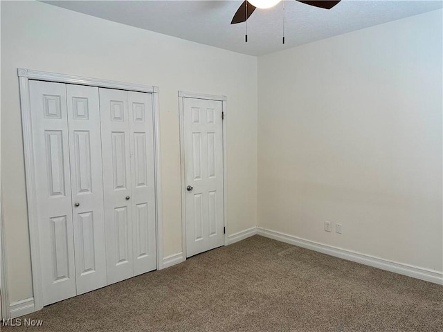 unfurnished bedroom featuring multiple closets, ceiling fan, and carpet floors