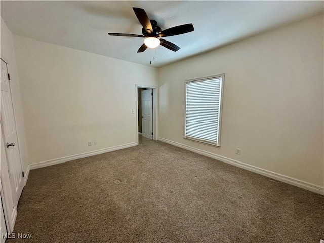 unfurnished bedroom with dark colored carpet and ceiling fan