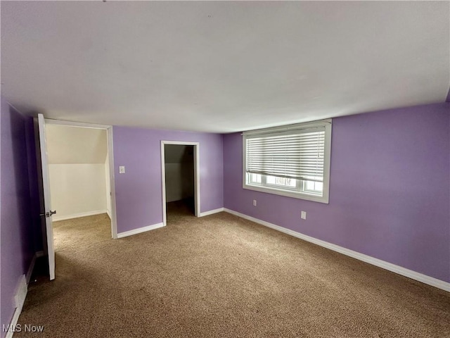 unfurnished bedroom featuring carpet flooring and a closet