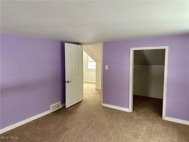 unfurnished room with light carpet