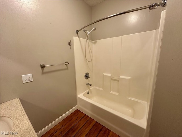 bathroom featuring hardwood / wood-style floors and shower / washtub combination