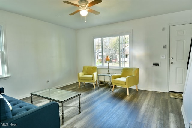 sitting room featuring dark hardwood / wood-style flooring and ceiling fan