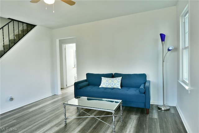 living room featuring wood-type flooring and ceiling fan