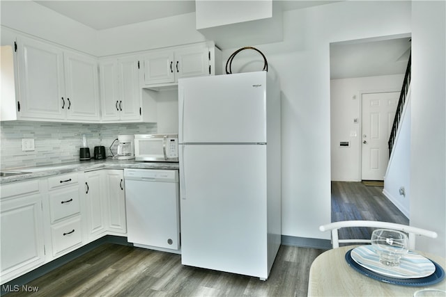 kitchen featuring dark hardwood / wood-style flooring, white cabinetry, and white appliances